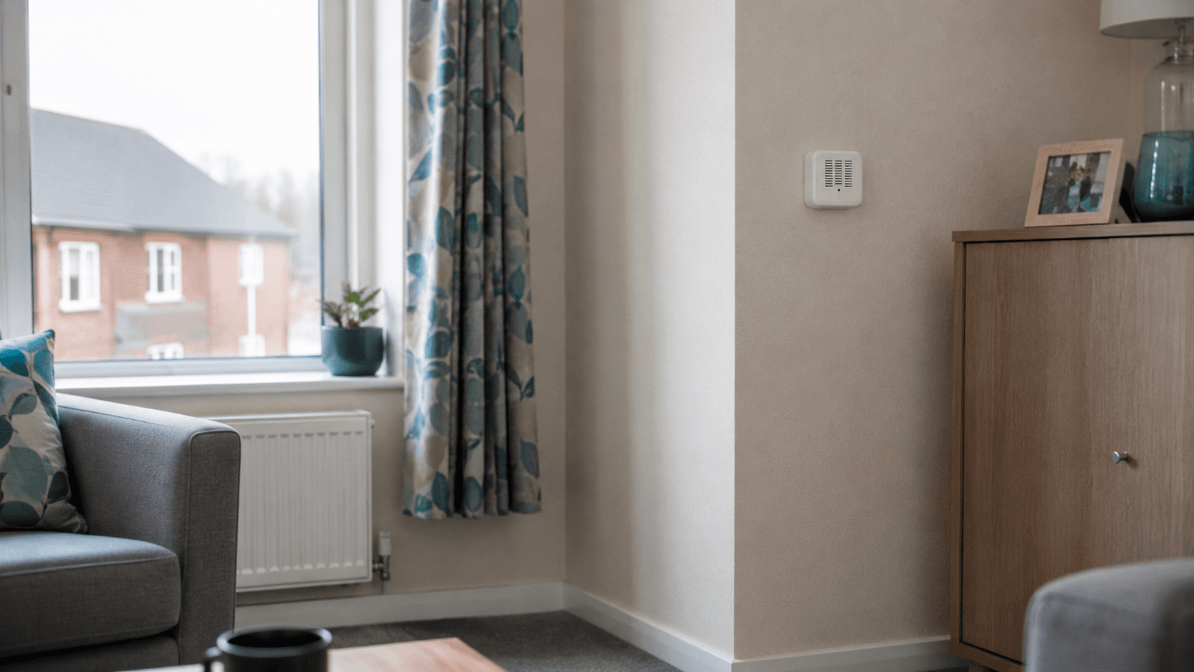 Aeroshi sensor installed on a wall in a managed home room